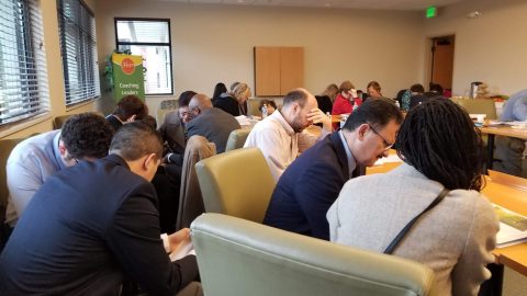 Washington Conference executive committee members pause
in prayer to thank God for answering a specific
tithing prayer.